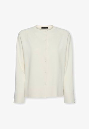 Flødefarvet cardigan med lange ærmer, knapper foran og rund halsudskæring med skjulte knapper ned foran.