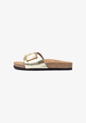 Gold metallic slide sandal with a wide strap and rectangular buckle, cork footbed, and textured black rubber sole. Flat and open design.