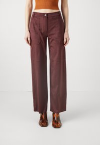 Maroon wide-leg pants made of smooth fabric; features two front pockets, a single button closure, and a tailored shape.