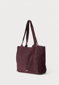 Burgundy suede tote bag with two long handles, a rectangular shape, and subtle stitching details. Features a small metal accent on the front.