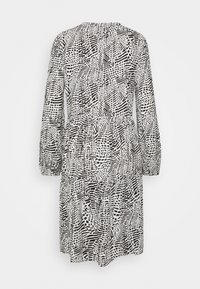 Long-sleeve dress in black and white, featuring a diverse abstract pattern, gathered waist, and tiered skirt design. Soft, lightweight fabric.