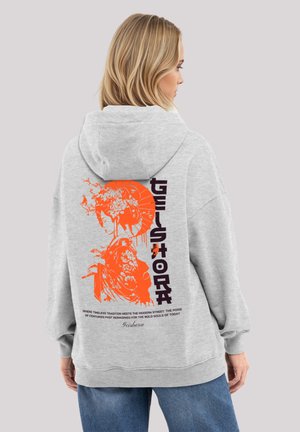 Gray sweatshirt with oversized fit. Back features vibrant orange graphic of a woman in traditional attire and bold text "Geishora."