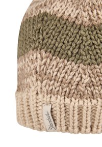 Beige and olive green knitted wool beanie with a folded hem and a small fabric tag on the edge.