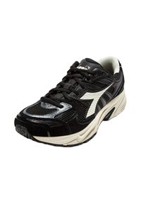 Bottine de sport noire avec une tige en mesh, des accents en suède texturé et un logo blanc. Dotée de lacets noirs et d'une semelle rembourrée beige.