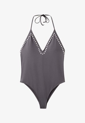 Maillot de bain une-pièce gris à col halter, avec un profond décolleté en V et des détails en clous argentés le long des bords.
