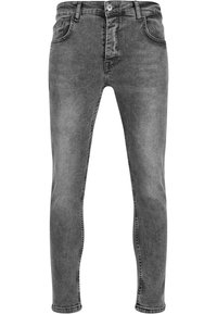 Jeans de mezclilla gris con un corte ajustado, que presentan un diseño clásico de cinco bolsillos y un cierre de cremallera con botón. Textura suave y acabado desvanecido.