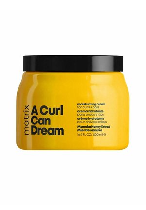 Gele pot met zwart deksel, gelabeld Matrix A Curl Can Dream hydraterende crème voor krullen met Manuka honingextract, 500 ml.