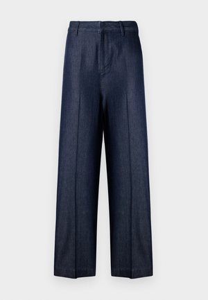 Mørkeblå vide denimbukser med høj talje, bæltestropper og pressede folder på forsiden af hvert ben.