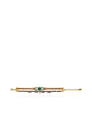 Gold-toned bracelet with two thin chains, green and clear gemstones in the center, and an adjustable clasp chain on a white background.