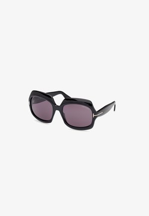 Occhiali da sole neri oversized con montatura esagonale, lenti scure e un delicato accento dorato sulle tempie, che mostrano una finitura lucida.