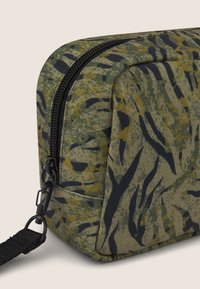 Beauty case con motivo mimetico realizzato in tessuto resistente; presenta una chiusura con zip e una superficie testurizzata con accenti neri.