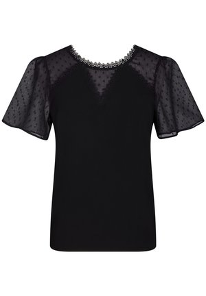 Haut noir avec un corps uni et des manches bouffantes transparentes. L'encolure est ornée de détails délicats en dentelle et d'un motif à petits pois subtil.