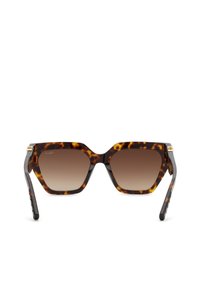 Lunettes de soleil carrées oversize à motif écaille de tortue, verres marron dégradés et accents dorés sur les charnières.