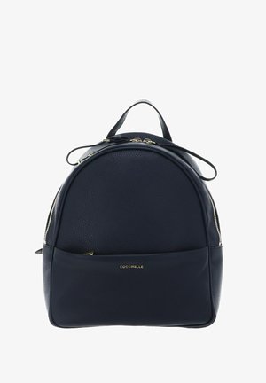 Black leather backpack with rounded top, gold zipper details, front pocket, and "Coccinelle" logo in gold lettering.