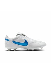 Botín de fútbol blanco hecho de cuero con una superficie texturizada y detalles en azul, que presenta un destacado logotipo de swoosh y tacas de goma moldeadas.