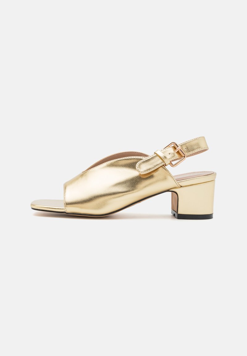 Gold metallic slingback sandal with a rounded open toe, block heel, and adjustable buckle strap. Smooth texture with a shiny finish.