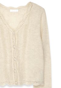 Cardigan in maglia beige chiaro con scollo a V, chiusura con bottoni e delicati motivi in pizzo. Orlo a scallop e dettagli in tessuto strutturato.