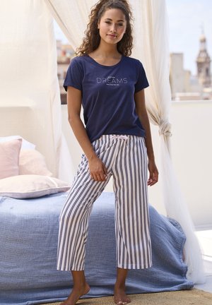 Navy cotton t-shirt with “DREAMS” text; white and navy striped cropped pants with a pink drawstring waistband. Floor-length, relaxed fit.