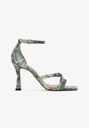 Højhælede sandal med grønt slangeskinds mønster, tynd ankelrem med guldlås og firkantet åben tå med to forreste remme.