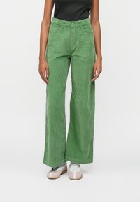 Green corduroy wide-leg pants with a high waist, two front pockets, and a single button closure. Features vertical ribbing texture.
