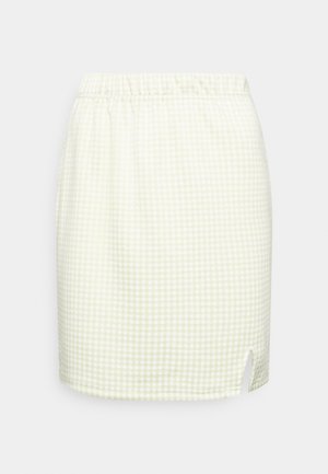 Saia em padrão vichy em verde-claro e branco. Apresenta uma cintura elástica e uma fenda lateral para maior liberdade de movimento. Tecido leve.