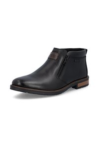 Bottine en cuir noir avec fermeture éclair latérale, bordure marron sur la semelle et petite languette à l'arrière, conçue pour un port décontracté ou formel.