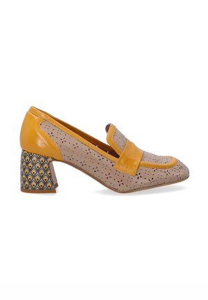 Beige leather loafers with a shiny yellow accent, featuring cut-out patterns and a patterned block heel in yellow, black, and white geometric design.