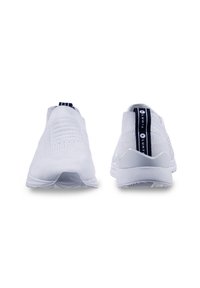 White slip-on sneakers with a textured knit upper, a navy accent stripe at the heel, and a lightweight rubber sole designed for comfort.