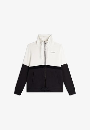 Giacca con zip caratterizzata da un colletto alto, parte superiore bianca e parte inferiore nera con una striscia di velluto. Include tasche laterali.