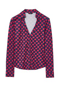 Long-sleeve button-up shirt in navy blue with red and pink polka dots, featuring a collar and smooth fabric texture.