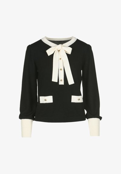 Črna pulover s kremnimi poudarki, ki ima mašno, zapiranje z gumbi, napihnjene rokave in dve sprednji žepi z zlatimi gumbi.