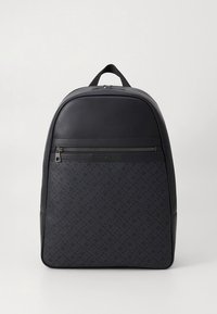 Black backpack made of smooth leather and patterned fabric, featuring a front zipper pocket and top handle, with a sleek, modern design.