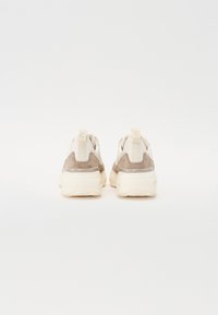 Kreem ja beežid tossud tekstureeritud ülemise osa, nahast detailide ja polsterdatud kannaosaga. Includes a small heel tab for easy wearing.