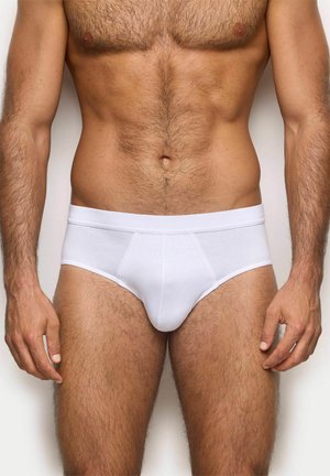 Bañadores de algodón blancos con una cinturilla suave, que cuentan con un ajuste ajustado y una textura lisa. Diseño ajustado con detalles de costura mínimos.