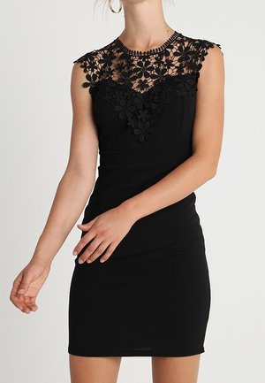Black fitted dress with a sleeveless design, featuring a floral lace neckline and contouring seams. Smooth fabric texture, knee-length.