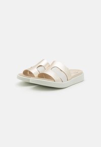 Open-toe sandals with a soft, metallic light gold upper and contrasting white straps. Features a cushioned footbed and a white sole.