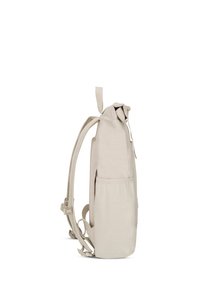 Beige backpack with padded straps, a side mesh pocket, roll-top closure, and adjustable buckles shown from the side on a white background.