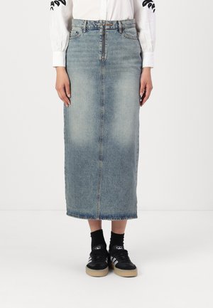 Light blue denim midi skirt with a straight cut, front zipper, and frayed hem. Paired with black sneakers and socks.