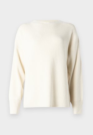 Pull en ribbed de couleur crème clair avec un col rond, des épaules tombantes et des manches longues. Fabriqué en tissu tricoté doux.