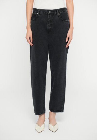 Black denim jeans with a relaxed fit, featuring a button closure, belt loops, and front pockets. Smooth texture and minimal design.