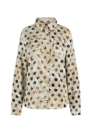 Beige button-up long-sleeve shirt with black and brown polka dots and white abstract brushstroke patterns, featuring two chest pockets.