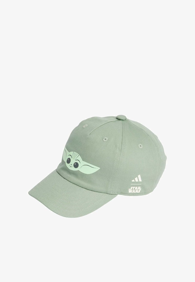 Green cotton baseball cap featuring a cartoon character with large eyes and ears on the front, with a white logo on the side.