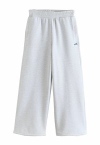 Light gray wide-leg sweatpants with elastic waistband and side pockets, featuring small "self." text on the right thigh.