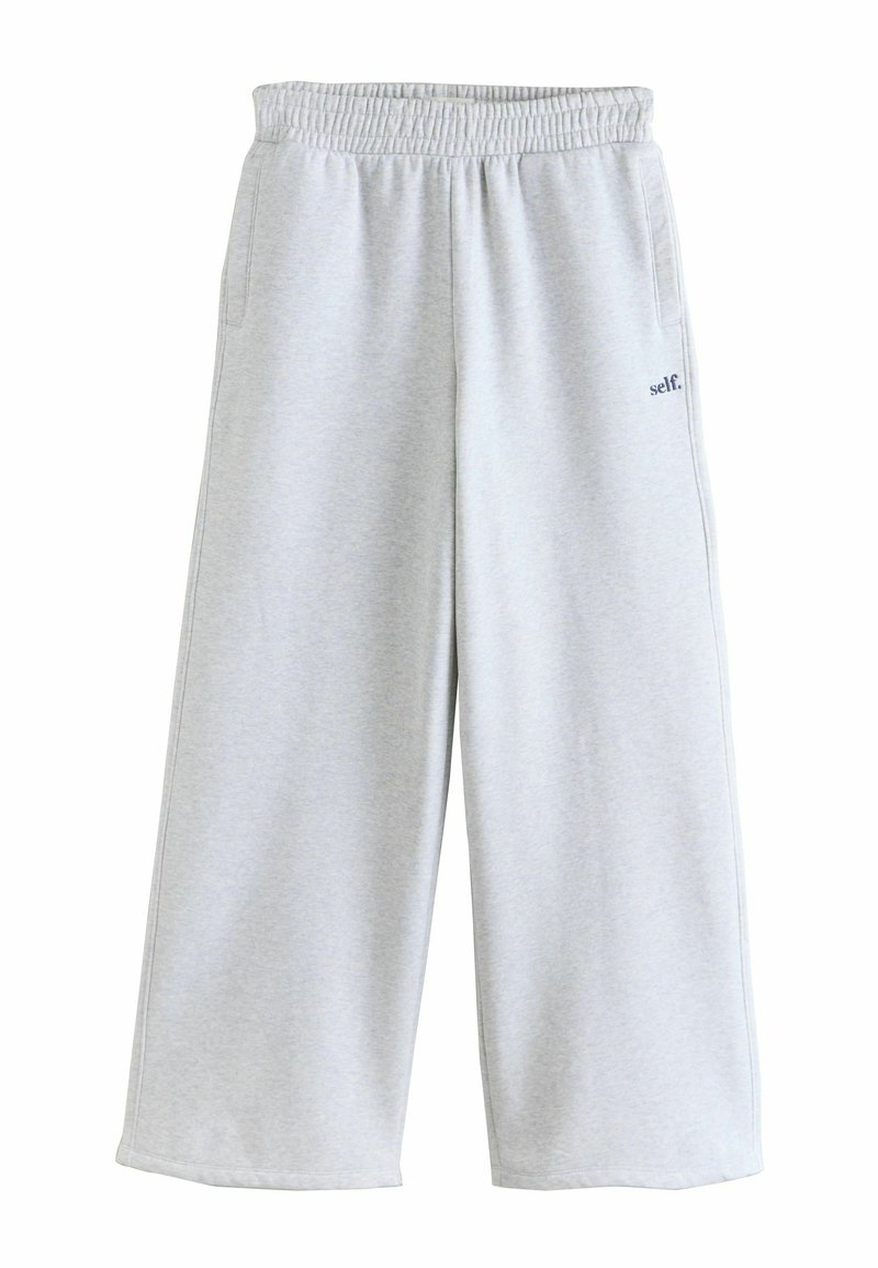 Light gray wide-leg sweatpants with elastic waistband and side pockets, featuring small "self." text on the right thigh.