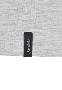 Gray ribbed fabric with a black label. The label features white text reading "Sterntaler." Simple and textured material design.