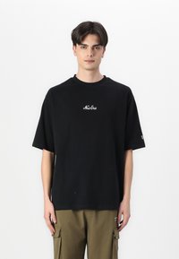 Black cotton t-shirt featuring short sleeves and a round neck, with white "New Era" logo embroidered on the chest.