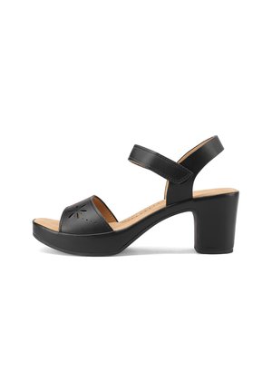 Sandalo in pelle nera con punta aperta, design perforato e cinturino alla caviglia regolabile. Presenta un tacco spesso per supporto e comfort.