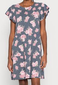 Blommig klänning i mjukt tyg, med en blå botten och rosa rosor, volangärmar, rund halsringning och en flerlagerskjol.