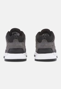 Gray suede and black mesh sneakers with a low profile, featuring a white midsole and dark rubber outsole, seen from the back.