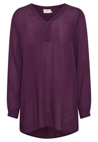Långärmad, lös passform blus i mörklila, med V-ringning och en subtil textur. Sömmen är rundad med en längre bakdel.